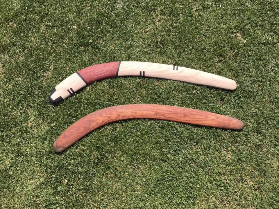 Two painted rabbitsticks lying on the ground