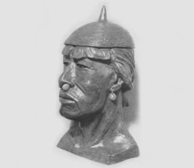 An ornament of an Asian man in silver color
